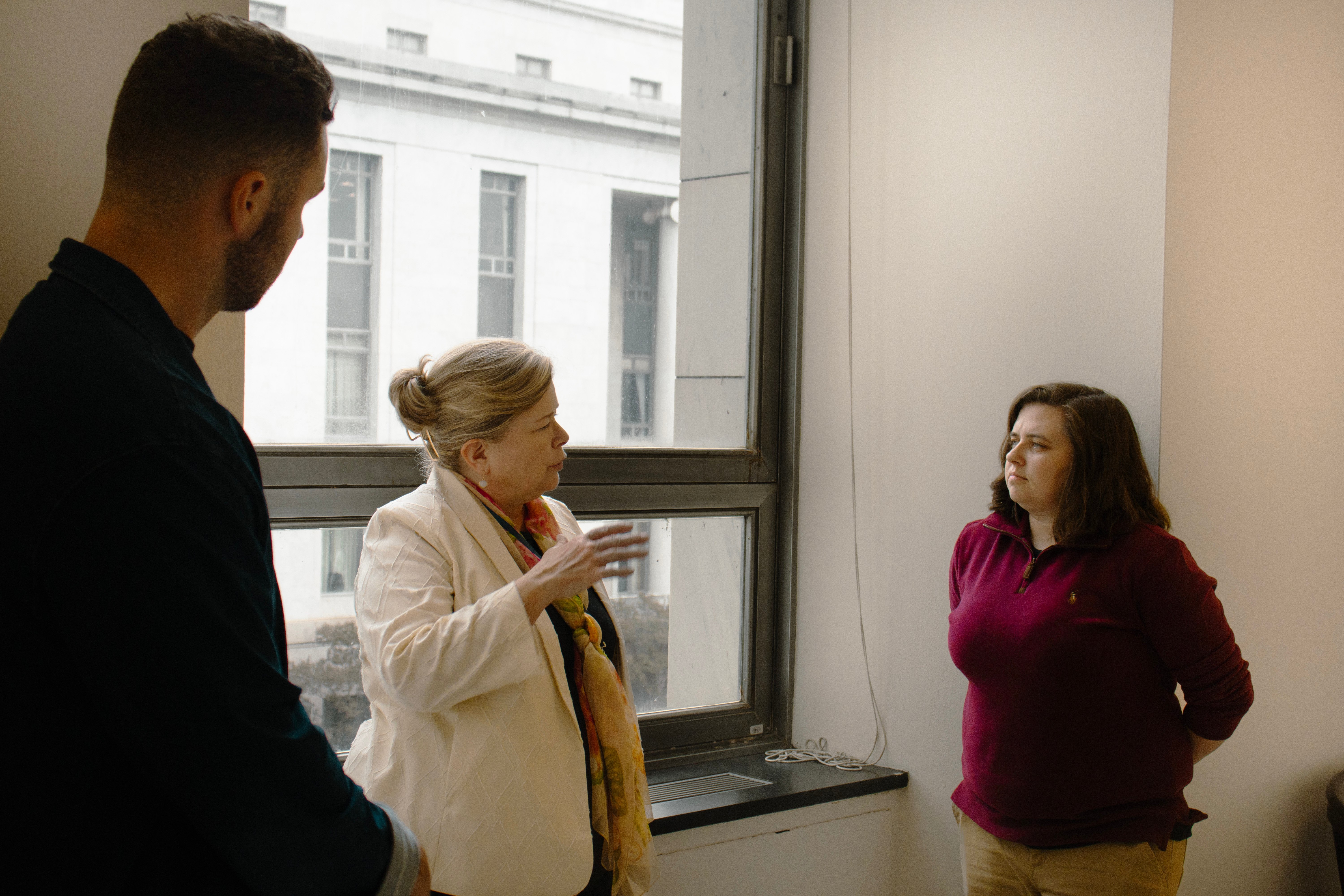 people discussing topics in a hallway