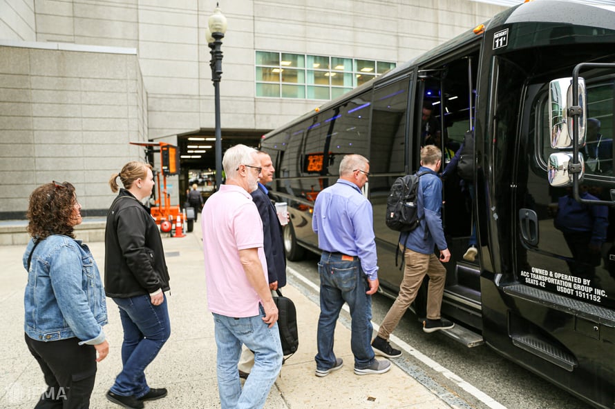 facility fusion attendees getting on a tour bus