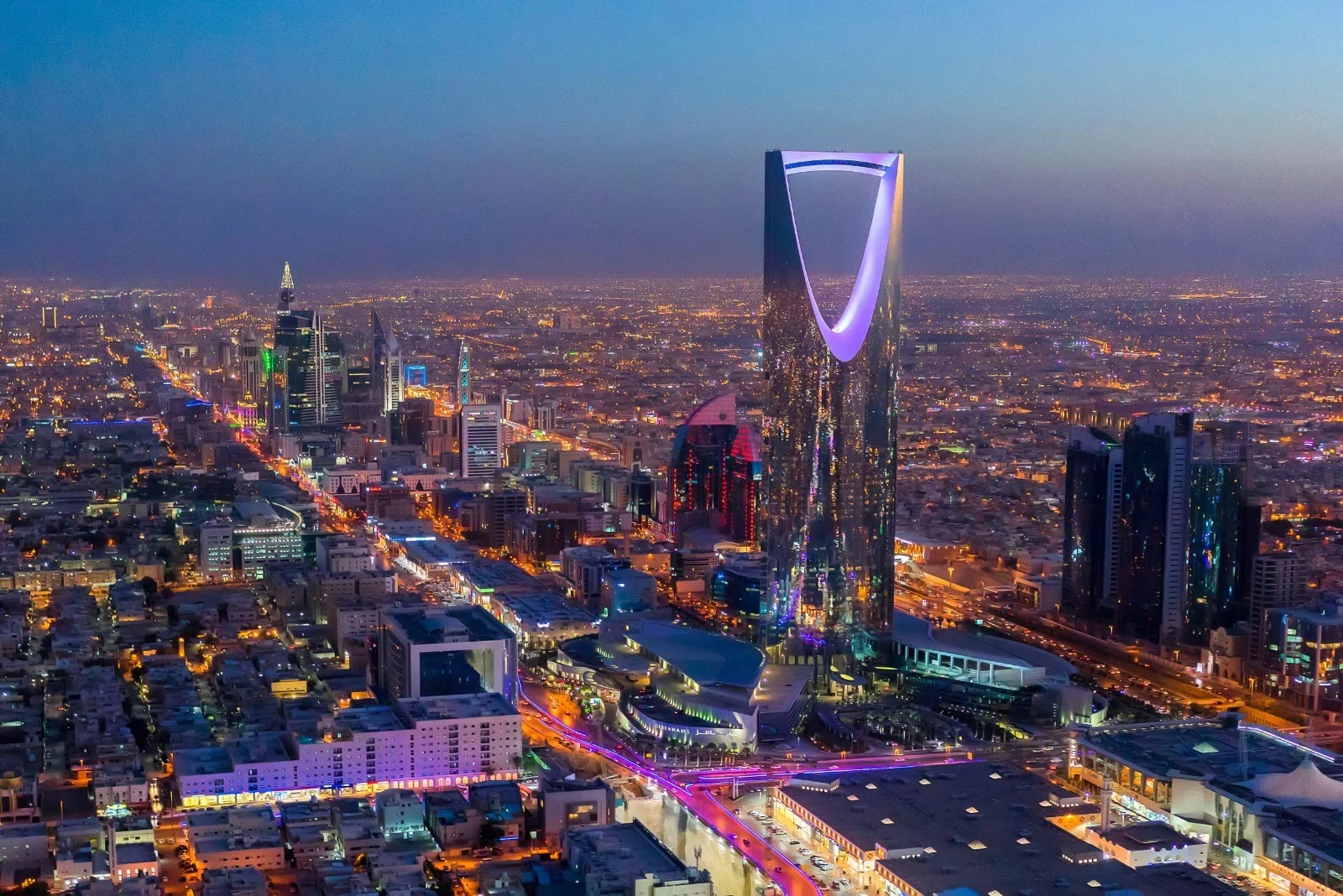 Aerial view of a modern city skyline at dusk in Saudi Arabia