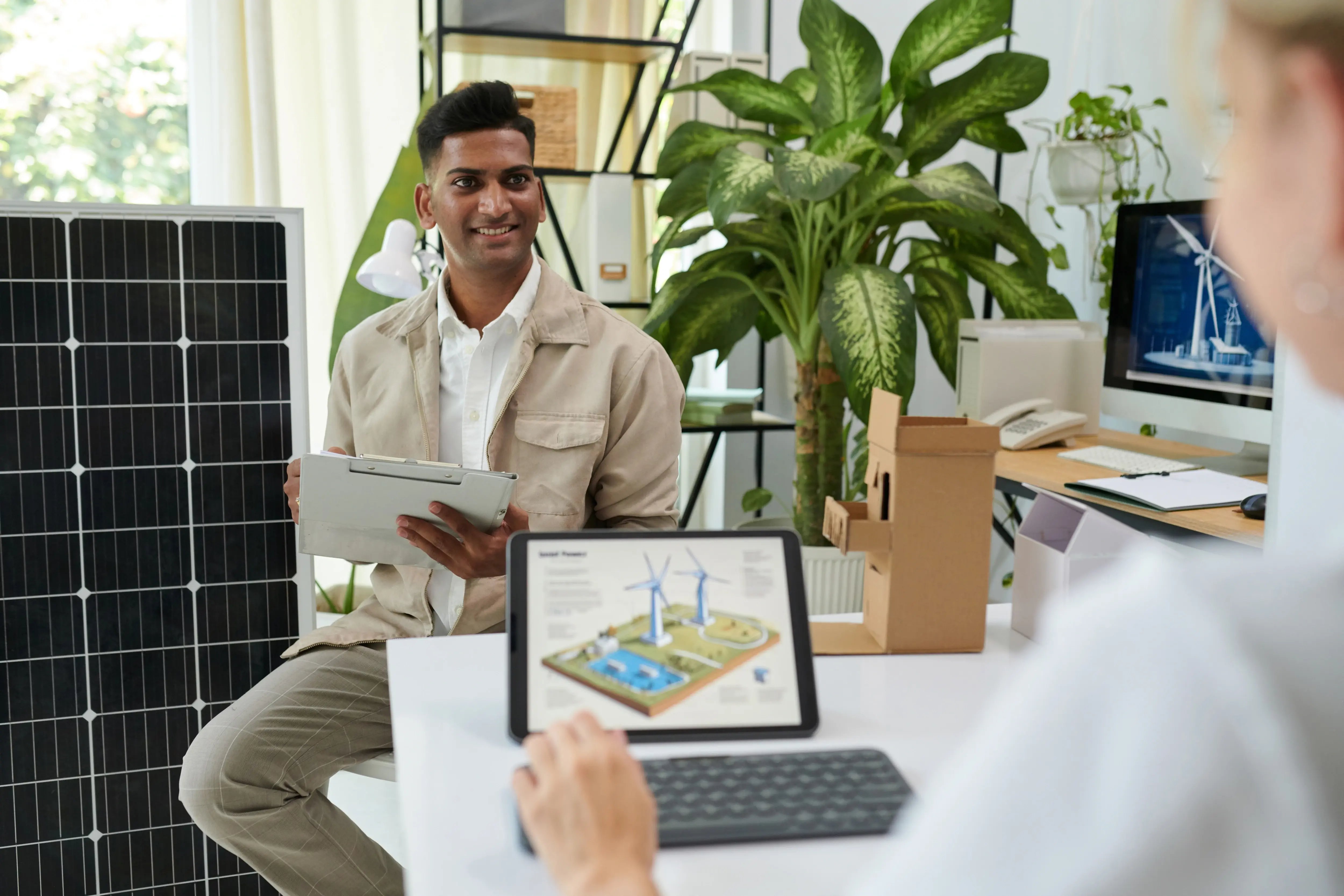 Modern facility manager reviewing building systems on a tablet